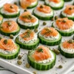 Fresh Smoked Salmon Cucumber Bites garnished with dill and capers.